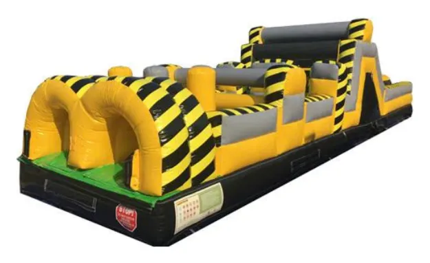 Construction Obstacle Course: a yellow and black hazard-striped inflatable obstacle course with grey pillars and a climbing wall