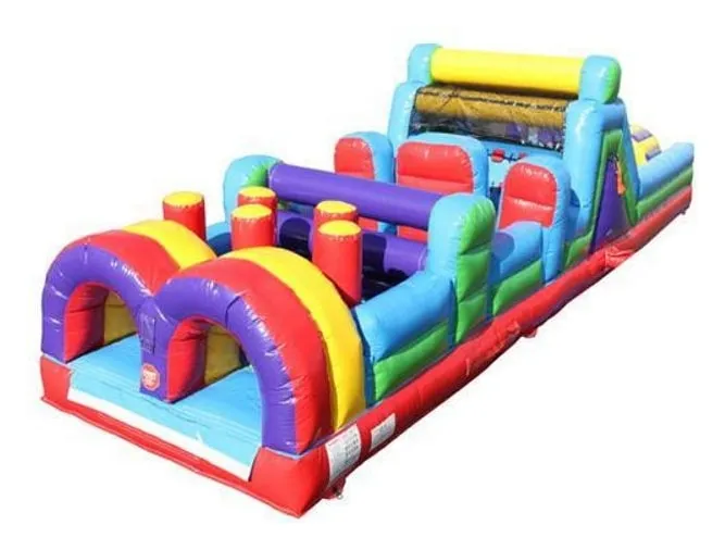 Rainbow Obstacle Course: a long inflatable course in red, yellow, blue, green and purple with twin entry arches, pop-up pillars and a climbing wall
